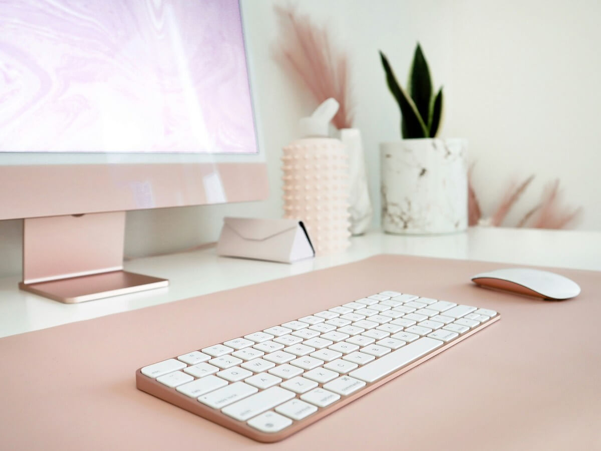 Pink computer with a white keyboard